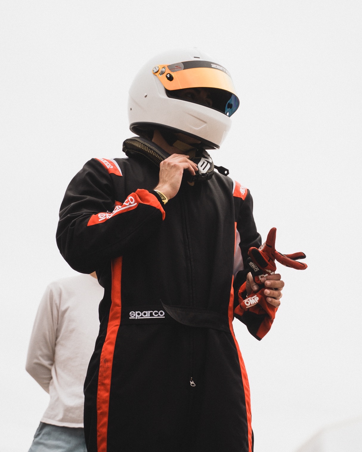 A Gold Trail Racing driver in a race suit and helmet